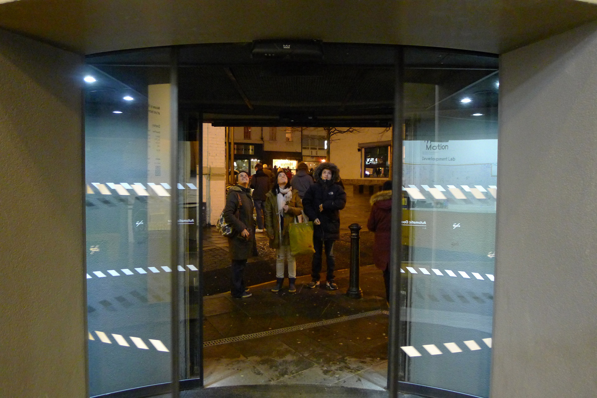 People looking up at the dot matrix video wall